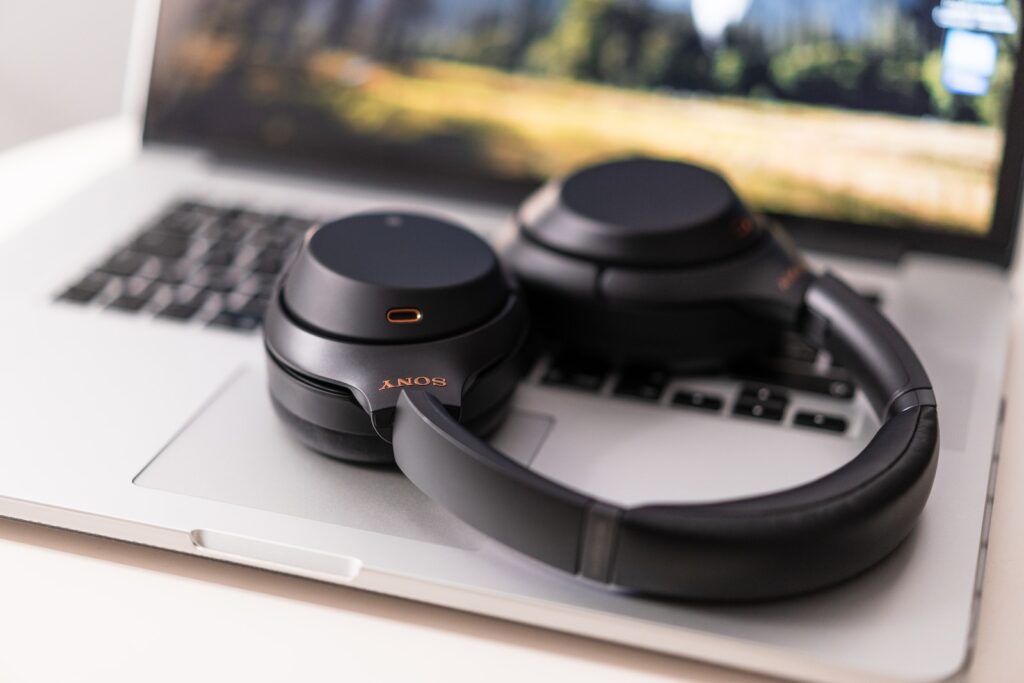 black and gray headphones on macbook pro
